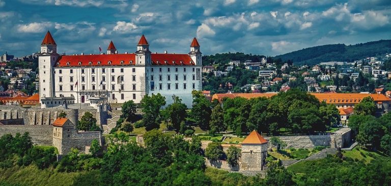 Ultimate Slovakia Bucket List 20 Bratislava Castle with its white façade and red roofs seen from a distance